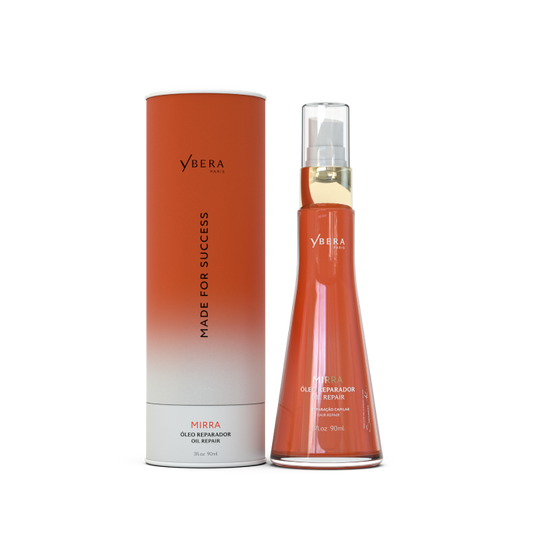 Aceite reparador Mirra de Ybera Paris en frasco naranja con dosificador junto a su estuche cilíndrico naranja y blanco.-3